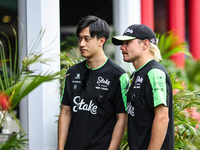 Guanyu Zhou of the Stake F1 Team and Valtteri Bottas of the Stake F1 Team pose with the Sauber C44 during the Formula 1 Singapore Grand Prix...