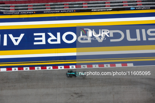 Fernando Alonso of the Aston Martin F1 Team AMR24 competes during the Formula 1 Singapore Grand Prix 2024 on the Marina Bay Circuit in Singa...