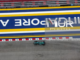 Fernando Alonso of the Aston Martin F1 Team AMR24 competes during the Formula 1 Singapore Grand Prix 2024 on the Marina Bay Circuit in Singa...