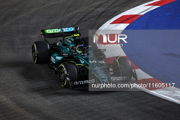 Fernando Alonso of the Aston Martin F1 Team AMR24 competes during the Formula 1 Singapore Grand Prix 2024 on the Marina Bay Circuit in Singa...