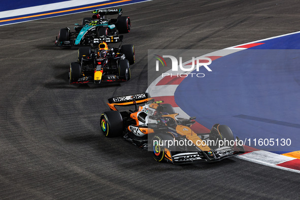 Lando Norris of McLaren F1 Team MCL38, Max Verstappen of Red Bull Racing RB20, and Lewis Hamilton of Mercedes AMG F1 Team W15 are in action...