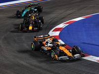 Lando Norris of McLaren F1 Team MCL38, Max Verstappen of Red Bull Racing RB20, and Lewis Hamilton of Mercedes AMG F1 Team W15 are in action...