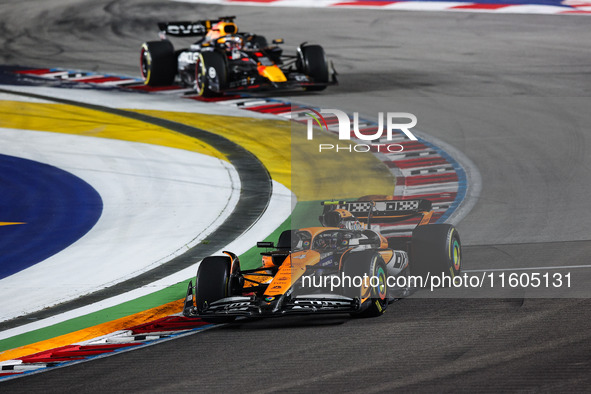 Lando Norris of McLaren F1 Team MCL38 and Max Verstappen of Red Bull Racing RB20 are in action during the Formula 1 Singapore Grand Prix 202...