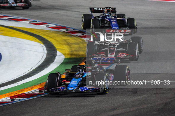 Esteban Ocon of Alpine F1 Team A524 and Kevin Magnussen of Haas F1 Team VF-24 Ferrari are in action during the Formula 1 Singapore Grand Pri...