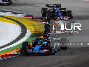 Esteban Ocon of Alpine F1 Team A524 and Kevin Magnussen of Haas F1 Team VF-24 Ferrari are in action during the Formula 1 Singapore Grand Pri...