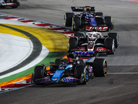 Esteban Ocon of Alpine F1 Team A524 and Kevin Magnussen of Haas F1 Team VF-24 Ferrari are in action during the Formula 1 Singapore Grand Pri...