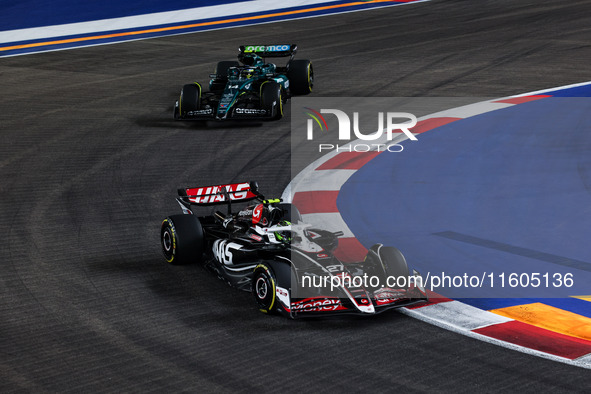 Nico Hulkenberg of Haas F1 Team and Fernando Alonso of Aston Martin F1 Team in action during the Formula 1 Singapore Grand Prix 2024 on the...