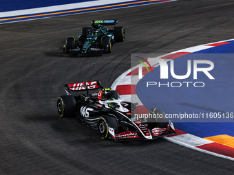 Nico Hulkenberg of Haas F1 Team and Fernando Alonso of Aston Martin F1 Team in action during the Formula 1 Singapore Grand Prix 2024 on the...