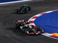 Nico Hulkenberg of Haas F1 Team and Fernando Alonso of Aston Martin F1 Team in action during the Formula 1 Singapore Grand Prix 2024 on the...