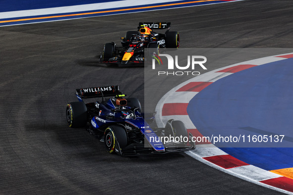 Franco Colapinto of Williams Racing FW45 and Sergio Perez of Red Bull Racing RB20 are in action during the Formula 1 Singapore Grand Prix 20...