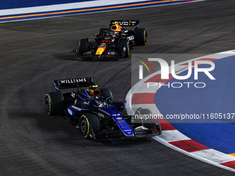 Franco Colapinto of Williams Racing FW45 and Sergio Perez of Red Bull Racing RB20 are in action during the Formula 1 Singapore Grand Prix 20...