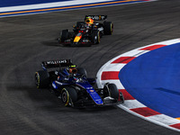 Franco Colapinto of Williams Racing FW45 and Sergio Perez of Red Bull Racing RB20 are in action during the Formula 1 Singapore Grand Prix 20...