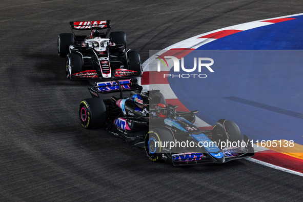 Esteban Ocon of Alpine F1 Team A524 and Kevin Magnussen of Haas F1 Team VF-24 Ferrari are in action during the Formula 1 Singapore Grand Pri...