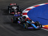 Esteban Ocon of Alpine F1 Team A524 and Kevin Magnussen of Haas F1 Team VF-24 Ferrari are in action during the Formula 1 Singapore Grand Pri...