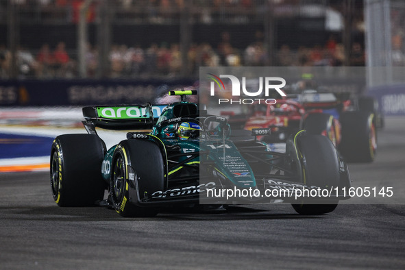 Fernando Alonso of the Aston Martin F1 Team AMR24 competes during the Formula 1 Singapore Grand Prix 2024 on the Marina Bay Circuit in Singa...