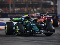 Fernando Alonso of the Aston Martin F1 Team AMR24 competes during the Formula 1 Singapore Grand Prix 2024 on the Marina Bay Circuit in Singa...