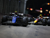 Franco Colapinto of Williams Racing FW45 and Sergio Perez of Red Bull Racing RB20 are in action during the Formula 1 Singapore Grand Prix 20...