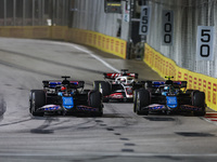 Esteban Ocon of the Alpine F1 Team in action and Pierre Gasly of the Alpine F1 Team in action during the Formula 1 Singapore Grand Prix on t...