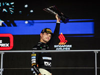 Lando Norris of the McLaren F1 Team MCL38 stands on the podium during the Formula 1 Singapore Grand Prix in Singapore, on September 19 to 22...