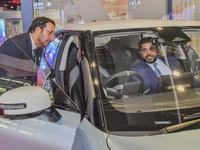 The Undersecretary of Economic Affairs of the Ministry of Economic Affairs of the United Arab Emirates (1st L) visits the Dongfeng Motor Exh...