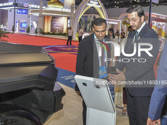 The UnderSecretary of Economic Affairs of the Ministry of Economic Affairs of the United Arab Emirates (1st R) visits the Dongfeng Motor Exh...