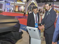 The UnderSecretary of Economic Affairs of the Ministry of Economic Affairs of the United Arab Emirates (1st R) visits the Dongfeng Motor Exh...