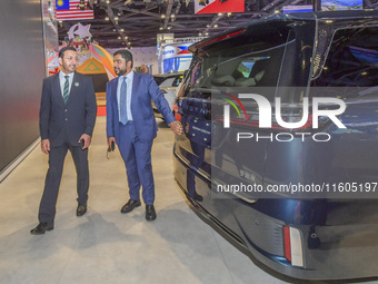 The Undersecretary of Economic Affairs of the Ministry of Economic Affairs of the United Arab Emirates (1st L) visits the Dongfeng Motor Exh...