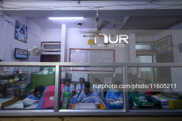 Doctors work at the nursing station of a ward treating dengue-infected patients at Sukraraj Tropical and Infectious Disease Hospital in Kath...