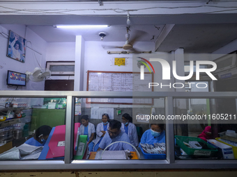 Doctors work at the nursing station of a ward treating dengue-infected patients at Sukraraj Tropical and Infectious Disease Hospital in Kath...