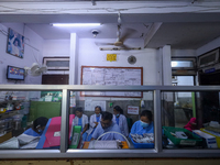 Doctors work at the nursing station of a ward treating dengue-infected patients at Sukraraj Tropical and Infectious Disease Hospital in Kath...