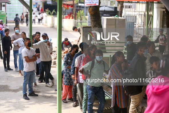 People stand in a queue to take tickets for check-up at the counter of Sukraraj Tropical and Infectious Disease Hospital in Kathmandu, Nepal...