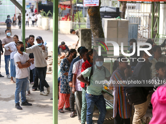 People stand in a queue to take tickets for check-up at the counter of Sukraraj Tropical and Infectious Disease Hospital in Kathmandu, Nepal...