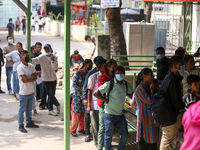 People stand in a queue to take tickets for check-up at the counter of Sukraraj Tropical and Infectious Disease Hospital in Kathmandu, Nepal...