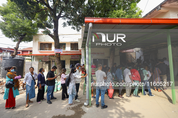 People stand in a queue to take tickets for check-up at the counter of Sukraraj Tropical and Infectious Disease Hospital in Kathmandu, Nepal...