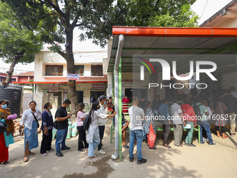 People stand in a queue to take tickets for check-up at the counter of Sukraraj Tropical and Infectious Disease Hospital in Kathmandu, Nepal...