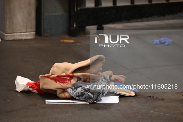 Bloody clothes and crime scene tape are at the scene. A man is stabbed at the East 138th Street and Grand Concourse MTA subway train station...