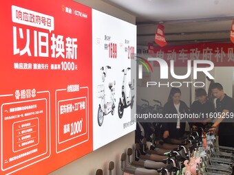 Consumers buy an electric bicycle at an electric bicycle trade-in promotion event in Yongnian district of Handan, China, on September 24, 20...