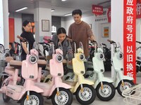 Consumers buy an electric bicycle at an electric bicycle trade-in promotion event in Yongnian district of Handan, China, on September 24, 20...