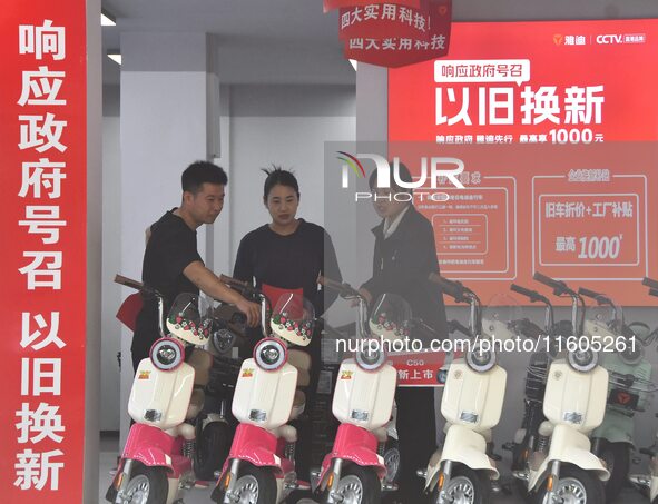 Consumers buy an electric bicycle at an electric bicycle trade-in promotion event in Yongnian district of Handan, China, on September 24, 20...