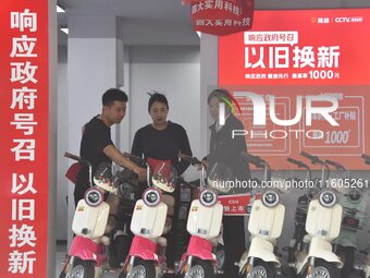 Consumers buy an electric bicycle at an electric bicycle trade-in promotion event in Yongnian district of Handan, China, on September 24, 20...