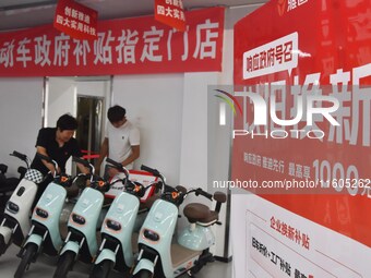 Consumers buy an electric bicycle at an electric bicycle trade-in promotion event in Yongnian district of Handan, China, on September 24, 20...