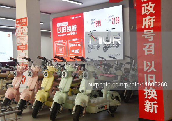 Consumers buy an electric bicycle at an electric bicycle trade-in promotion event in Yongnian district of Handan, China, on September 24, 20...