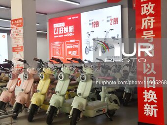 Consumers buy an electric bicycle at an electric bicycle trade-in promotion event in Yongnian district of Handan, China, on September 24, 20...