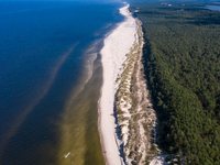 An aerial view of a beach, Baltic Sea and a forest late near Leba, famous pomeranian tourist resort in northern Poland as Autumn begins on S...