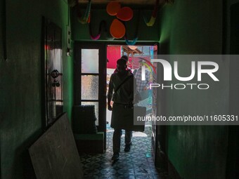 Polling officials enter a polling station after collecting election materials at a distribution center in Srinagar, Jammu and Kashmir, on Se...