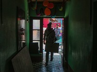 Polling officials enter a polling station after collecting election materials at a distribution center in Srinagar, Jammu and Kashmir, on Se...