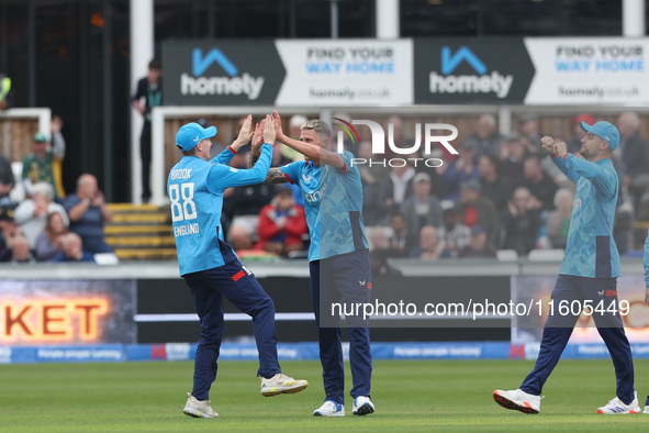 Brydon Carse of England celebrates with Harry Brook after catching Australia's Mitchell Marsh behind the wicket during the Metro Bank One Da...