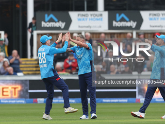 Brydon Carse of England celebrates with Harry Brook after catching Australia's Mitchell Marsh behind the wicket during the Metro Bank One Da...