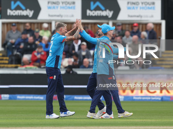 England's Brydon Carse celebrates with Will Jacks after having Australia's Mitchell Marsh caught behind the wicket in the Metro Bank One Day...