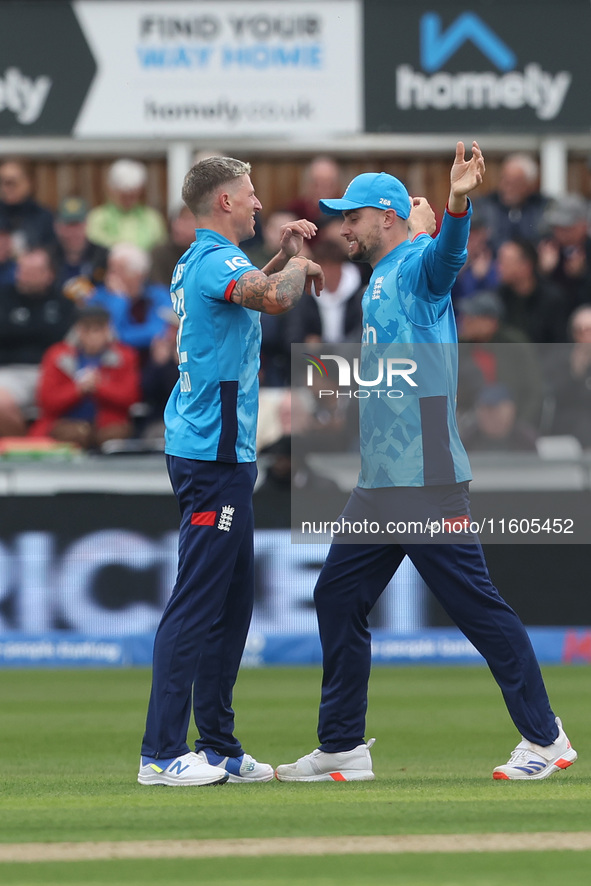 England's Brydon Carse celebrates with Will Jacks after having Australia's Mitchell Marsh caught behind the wicket in the Metro Bank One Day...